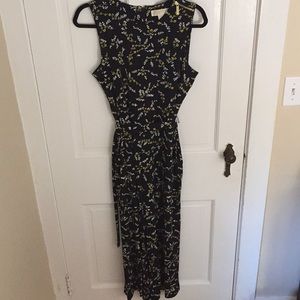 Black romper with white and yellow flowers